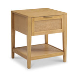 A wooden side table with a rattan-textured drawer and lower shelf stands against a white background, with no apparent action or activity.