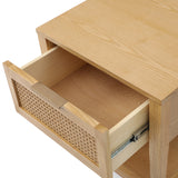 A wooden nightstand with an open drawer featuring a wicker front, set against an isolated white background.