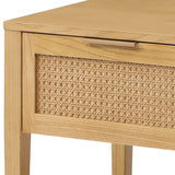 A wooden table with a caned drawer front and a metallic handle, positioned against a white background.