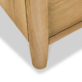 A wooden table leg intersects with the tabletop against a white background, showcasing the wood grain and joint detail.