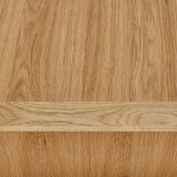 A wooden shelf against a vertical wood grain background, the shelf is empty and is in the foreground.