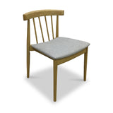 A wooden chair with a curved backrest and vertical slats, featuring a gray cushioned seat, stands alone against a white background.