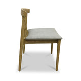 A wooden chair with a gray cushioned seat stands idle against a white background.