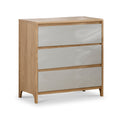 A wooden three-drawer chest with white, glossy front panels stands isolated against a white background.