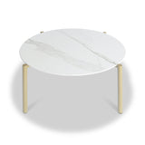 A round table with a marble top and three gold-colored legs stands isolated against a plain white background.