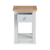 A wooden-top nightstand with a single grey drawer at a slight angle, against a white background.