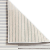 A striped carpet is partially rolled up to reveal its underside, set against a white background.