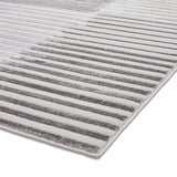 A striped gray and white rug on a white background, showcasing a partial view with an emphasis on texture and pattern.