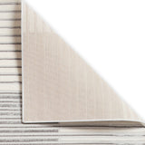 A beige carpet partially rolled up, revealing a striped pattern underneath, isolated on a white background.