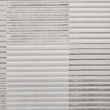 A textured surface with alternating horizontal bands of corrugated and smooth metallic appearance in grayscale, showing no discernible action or text, likely a material or abstract art.