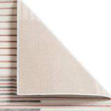 A folded rug reveals its striped pattern and textured fabric, contrasting with a plain white background.