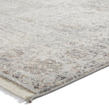 A textured rug with varying shades of beige and gray, resting on a white background.