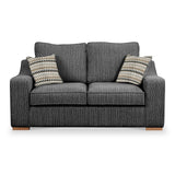 A gray textured sofa with two patterned cushions against a white background.