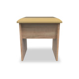 A small wooden desk with a tan cushioned top stands isolated against a white background.