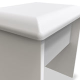 A white padded bench with a smooth finish is depicted, set against a monochromatic background enhancing its minimalistic design.