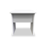 A white, minimalist desk stands centered against a white background, featuring a flat top and open shelf underneath.