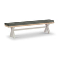 A rectangular bench with a cushioned top and white crisscross legs on a plain background.