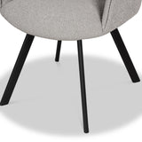 A chair with a textured light gray seat and angled black legs stands on a white surface, partly cropped at the top.