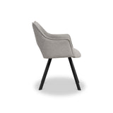 A light gray upholstered chair with a curved backrest and armrest, on angular black metal legs, stands against a white background.