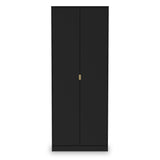 A tall black wardrobe stands with closed doors and a single gold-colored handle, isolated against a white background.