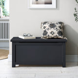 A dark-colored wooden storage bench with a closed lid, situated against a plain white background.