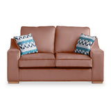 A brown leather sofa with two patterned cushions against a white background.