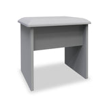 A gray, cushioned ottoman with an open shelf, standing isolated against a white background.