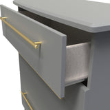 A partially opened gray drawer with a golden handle reveals a lined interior, in a simple, modern design against a neutral background.