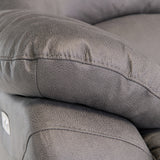 Close-up of a textured grey leather sofa cushion with visible stitching, depicting the detail and quality of the upholstery.