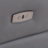 A metallic seat adjustment switch embedded in a textured grey airplane or car seat, suggesting an interior transportation setting.