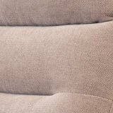 Folded beige fabric with a textured pattern, resting, likely a textile or garment in close-up view.