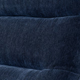 Textured denim fabric arranged with visible folds, giving a visual sense of softness and flexibility, typically associated with clothing material.