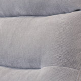 Gray fabric with a herringbone pattern, possibly upholstery, with folds indicating soft, cushioned surfaces.