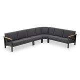 A curved sectional sofa with grey cushions on a black frame against a white background.