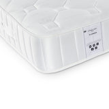 A white mattress with a quilted top and side labels indicating "ROSELAND FLORIDA," with symbols for recyclability and certifications, placed against a white background.