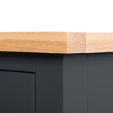 A wooden plank rests atop a black surface, joined by a strip of transparent adhesive tape at the corner, contrasting the natural and artificial textures.