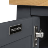 A metal nameplate on a drawer reads "ROSELAND," next to an open latch, with parts of a wooden surface and grey structure visible.