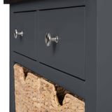 A black drawer with silver knobs partially open, revealing a woven basket inside, set against a neutral background.