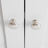 Two round, silver-colored knobs are centered on a pair of closed white cabinet doors, creating a symmetrical appearance.