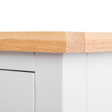 A wooden plank with a bandage, suggesting repair, against a white background with a blurred gray drawer unit beneath.