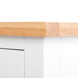 A wooden plank is patched with a beige bandage, bridging a crack, against a white background.