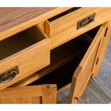 A wooden desk drawer is open, revealing the contents and construction against a parquet floor background.