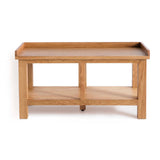 A wooden coffee table with a lower shelf stands against a white background.