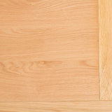 A light wooden floor exhibits natural grain patterns, with a perpendicular wooden plank along one edge, indoors. There is no text in the image.