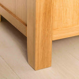 Leg view of the Abbey Light Oak Blanket Box by Roseland Furniture