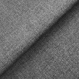 Textured gray fabric with a visible weave pattern folded over itself, casting a shadow, suggesting thickness and flexibility.