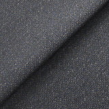 Close-up of a textured fabric with a folded edge, showing interwoven threads in shades of blue and some white, giving it a speckled appearance.