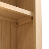 A wooden shelf corner with visible screws mounted on a vertical wood-paneled background, suggesting interior carpentry.