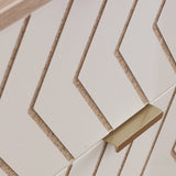 White rectangular cards with angled edges are stacked, supported by a gold-colored shelf against a pale background.