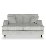 A grey fabric loveseat with plush cushions and dark wooden legs with brass casters, isolated on a white background.